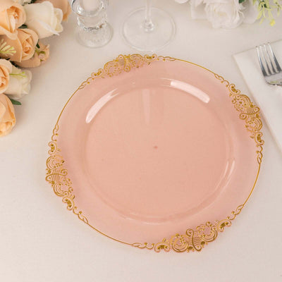 Pink decorative plate with gold accents on a plain backdrop.