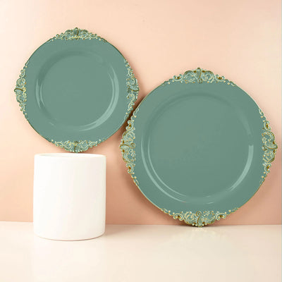 Elegant teal plates with gold ornate edges on pastel backdrop.