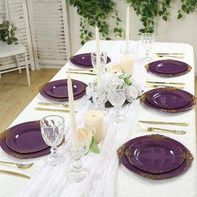 Elegant purple dinnerware set with gold accents on a beautifully arranged table.