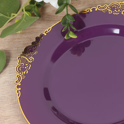 Purple decorative plate with gold trim on a textured surface.