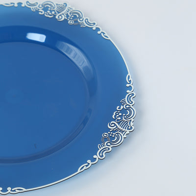 Blue decorative plate with intricate white trim design