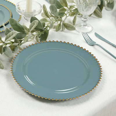 Teal plate with gold beaded rim on a table setting