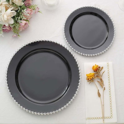 Black plates with silver beaded edges, styled with flowers and napkin.