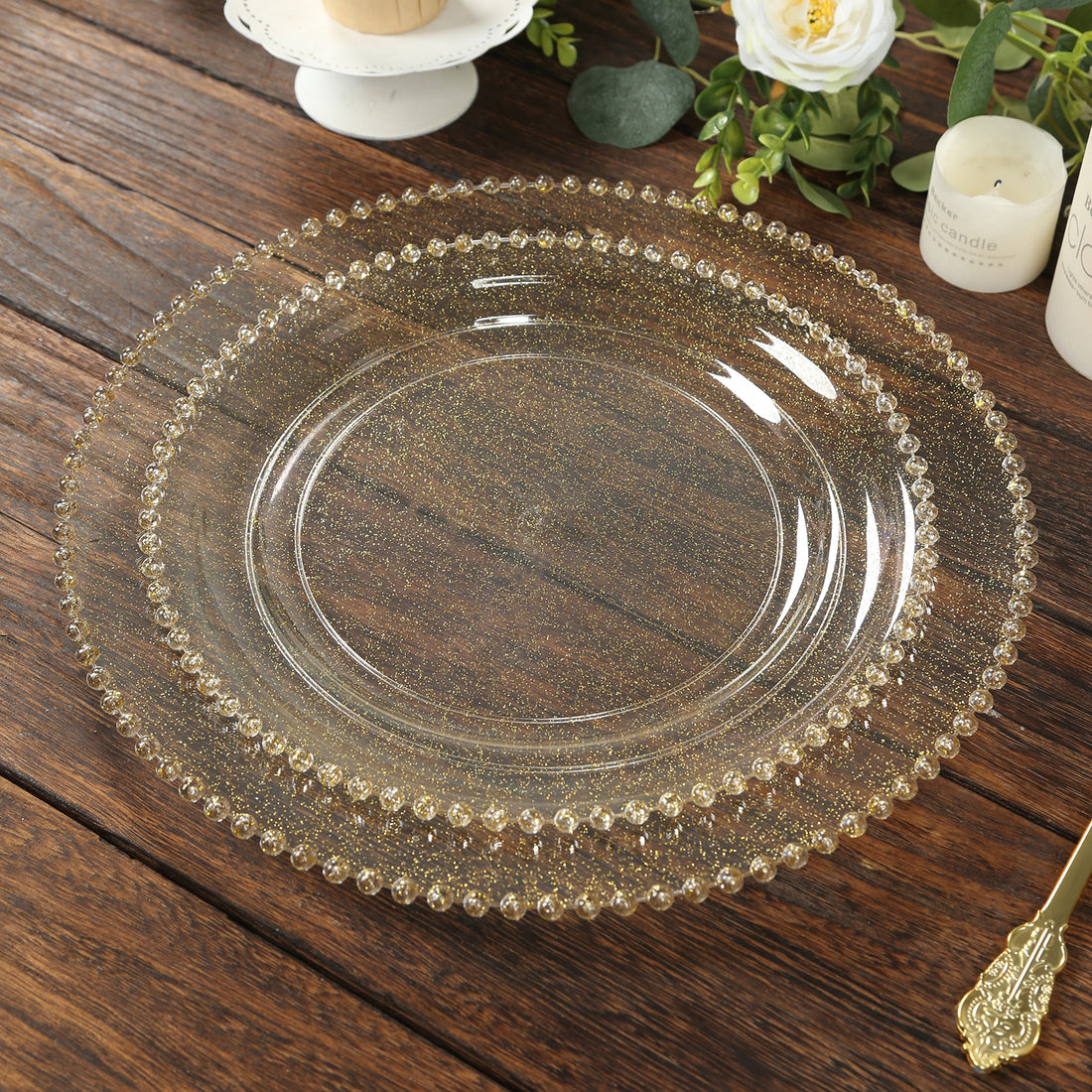 Gold beaded glass plate on wooden table surface.
