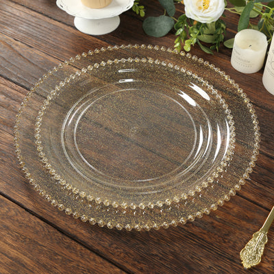 Gold beaded glass plate on wooden table surface.