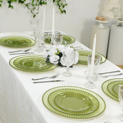 Elegant green glass dinnerware set arranged on a festive dining table.