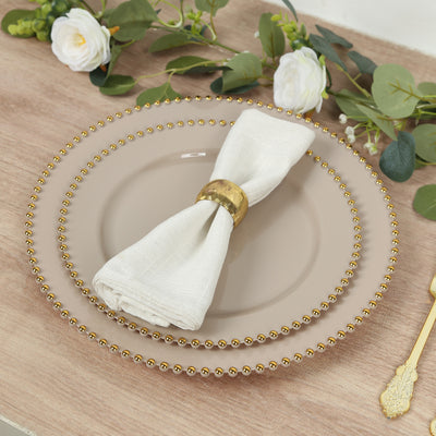 Elegant dinner plate set with gold beaded edge and white napkin.