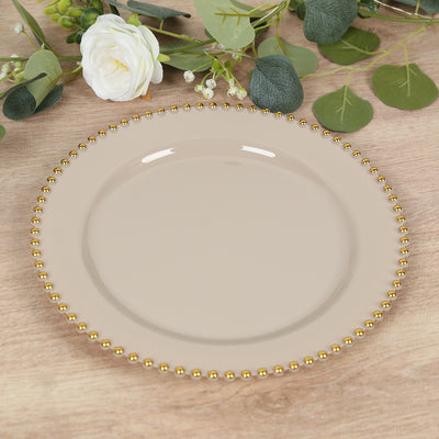 Beige plate with gold beaded rim on wooden surface.