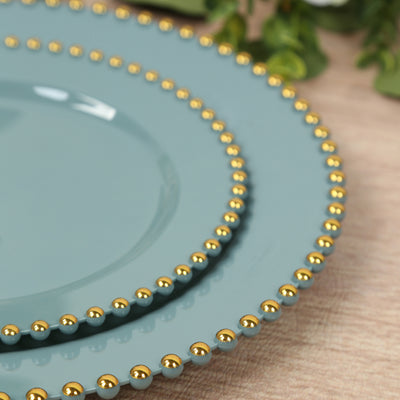Elegant teal plates with gold bead accents, stacked artfully.