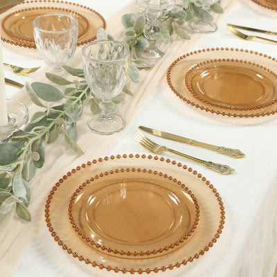 Elegant amber glass plates set on a beautifully arranged dining table.