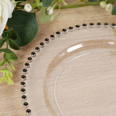 Clear plate with black beaded rim and floral accents.