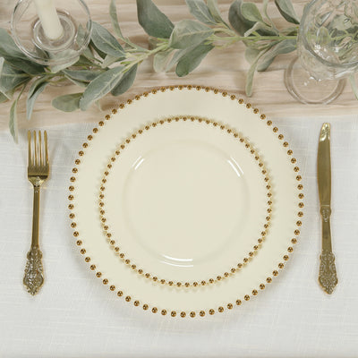 Elegant cream-colored dinner plate set with gold bead accents.