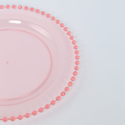 Pink decorative plate with bead-like edge detail.
