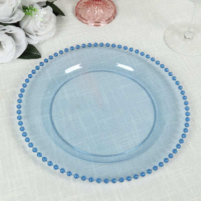 Blue beaded glass plate on a textured tablecloth