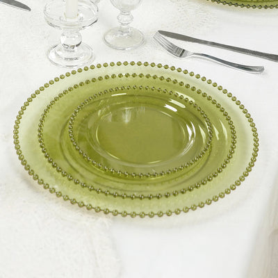 Green beaded glass plates set elegantly on a dining table.
