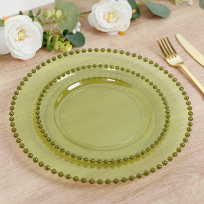 Green beaded edge dinnerware set on a wooden table with floral accents.