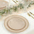 Elegant beige dinner plates with gold beaded trim on a beautifully set table.