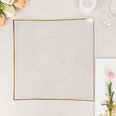 Clear square plate with gold rim on a neutral background