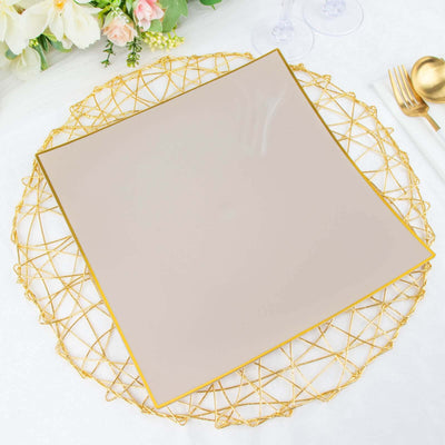 Elegant square plate with gold trim on a decorative gold placemat.