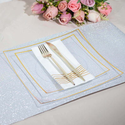 Elegant table setting with silver and gold plates, fork, knife, and napkin.