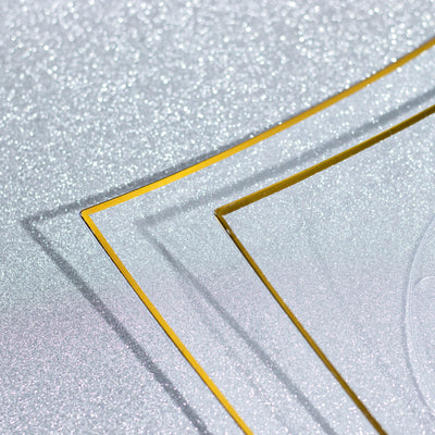 Glittery silver background with gold edges, showcasing an elegant design.
