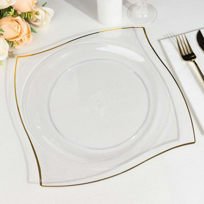 Elegant clear glass plate with gold rim, styled with floral arrangement.
