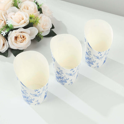 Three floral-patterned paper cups arranged on a table.