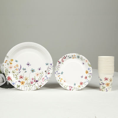 Floral design disposable plates and cups on a plain background.