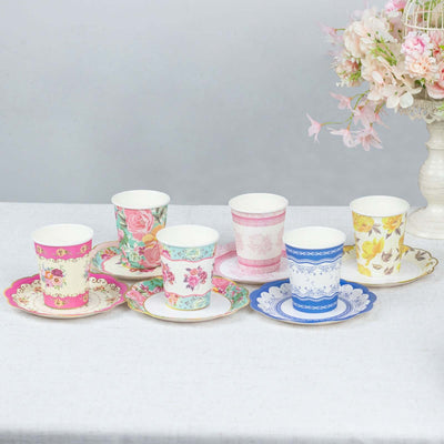 Colorful floral paper cups and saucers arranged on a table.