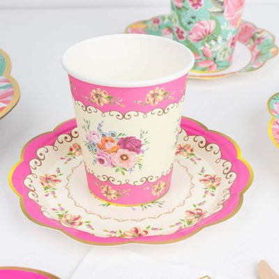 Floral patterned paper cup on a decorative plate with vibrant colors.