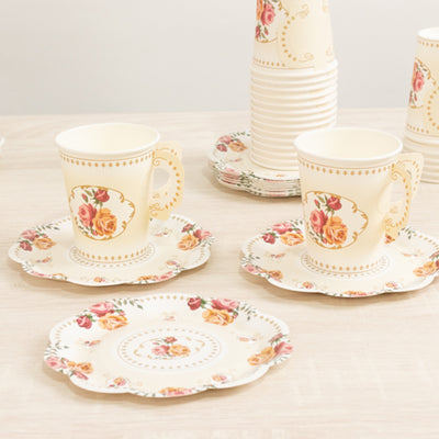 Floral patterned cups and plates arranged on a light surface.