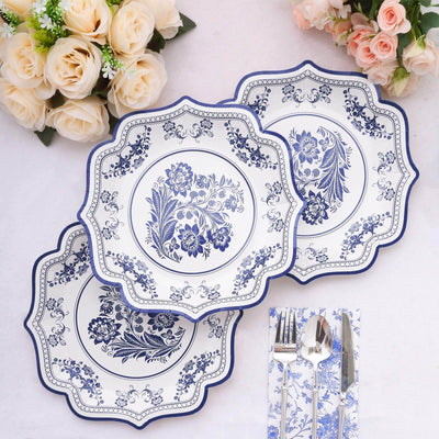 Elegant blue and white floral pattern dinner plates set on a table with roses.