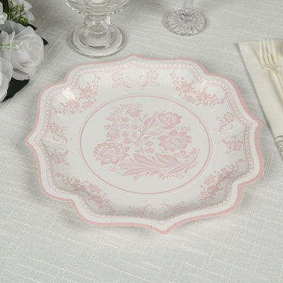 Elegant pink floral patterned plate on a textured tablecloth.