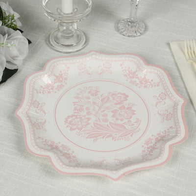 Elegant pink floral design plate on a textured table setting.