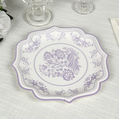 Decorative lavender floral plate on a textured tablecloth.