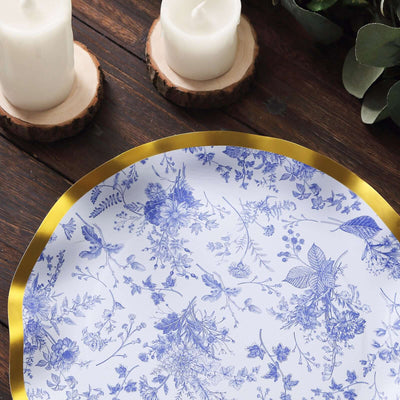Decorative blue floral plate with gold trim on a rustic wooden table.