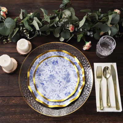 Elegant table setting with blue floral plates and gold accents.