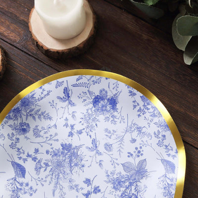 Elegant floral-patterned plate with gold rim on rustic wooden surface.