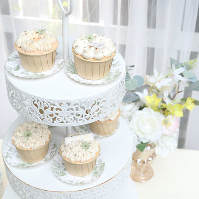 Decorative cupcakes displayed on a tiered stand with floral accents.