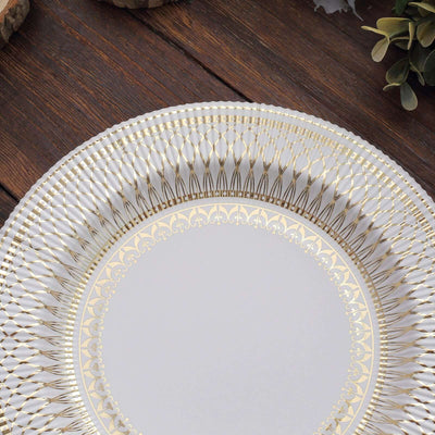 Elegant gold rimmed decorative plate on wooden background.