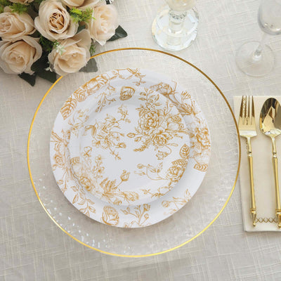 Elegant gold floral dinnerware set on a textured tablecloth with roses.