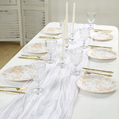 Elegant dinner table setting with floral plates and glassware.