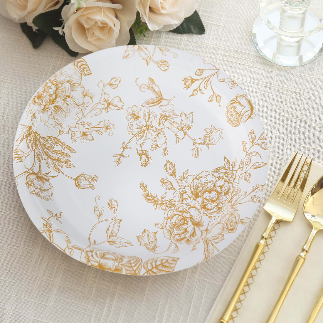 Elegant gold floral design paper plate on a textured table setting.
