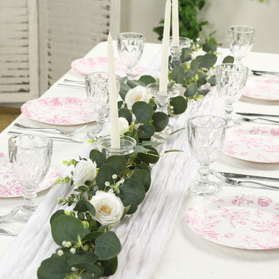 Elegant table setting with floral decor and candles for a special occasion.