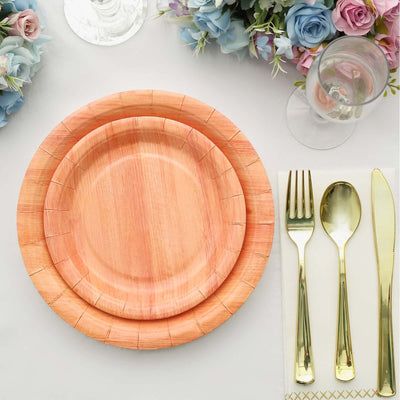 Wooden disposable plates set with gold cutlery and floral decor