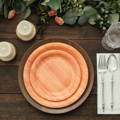 Set of eco-friendly disposable plates in peach tones, styled for dining.