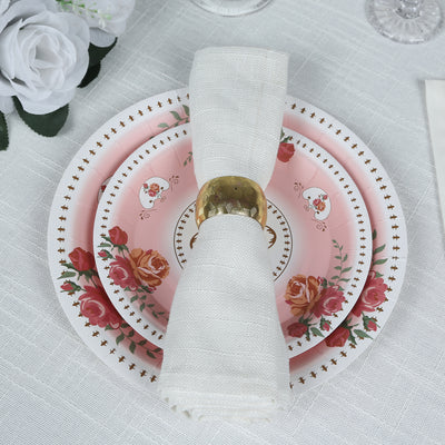 Elegant pink floral dinner plate set with white napkin and gold ring.