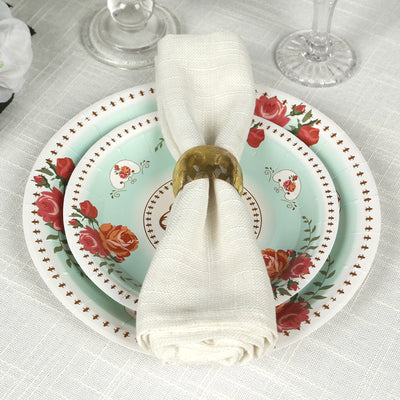 Elegant dinnerware set with floral designs and a folded napkin.