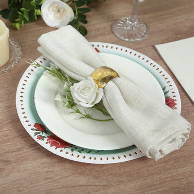 Elegant table setting with decorative napkin and floral accents.