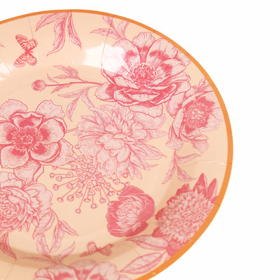 Floral patterned bowl with pink and orange design on a peach background.